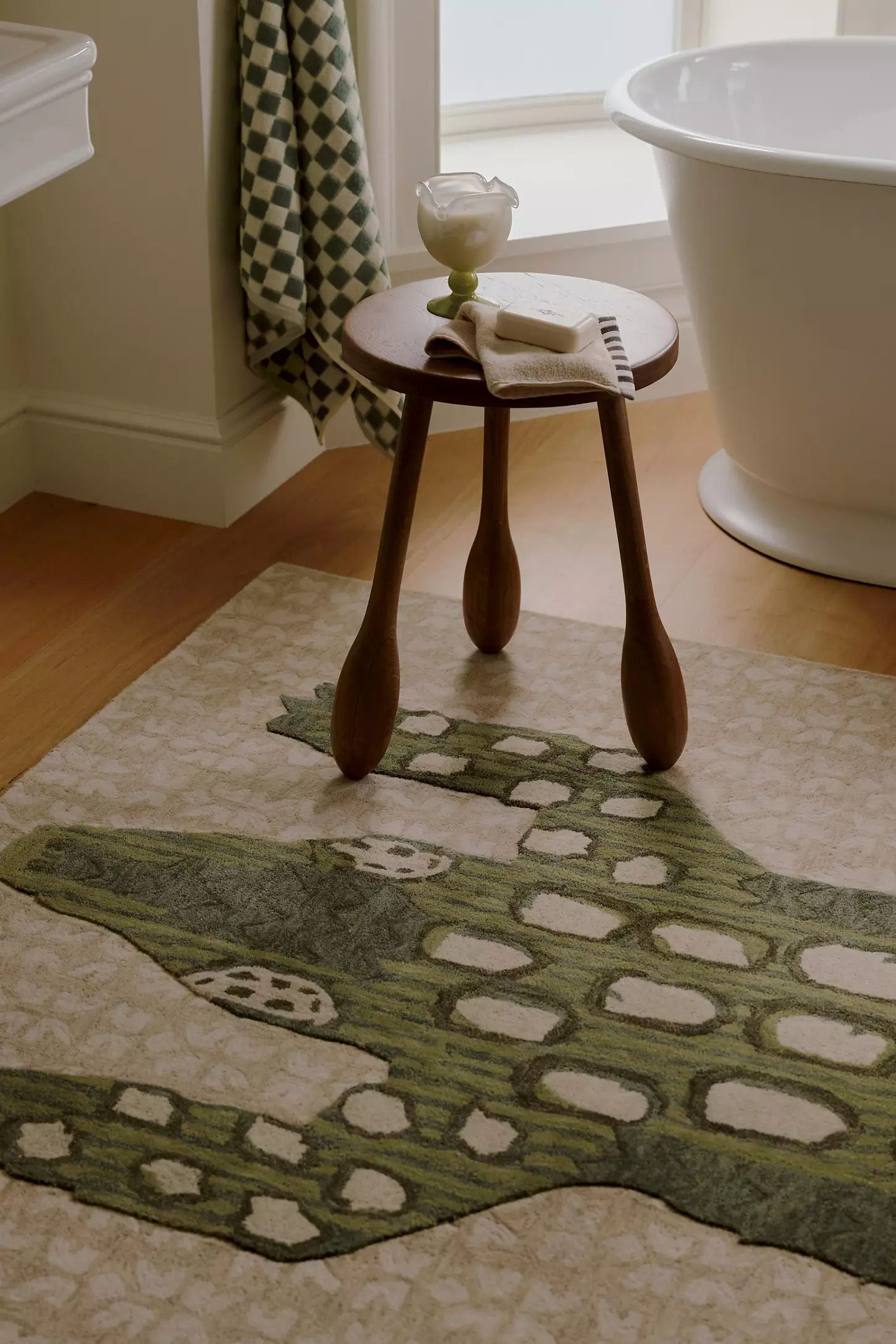 alligator design   Wooden stool on a patterned rug in a bathroom setting